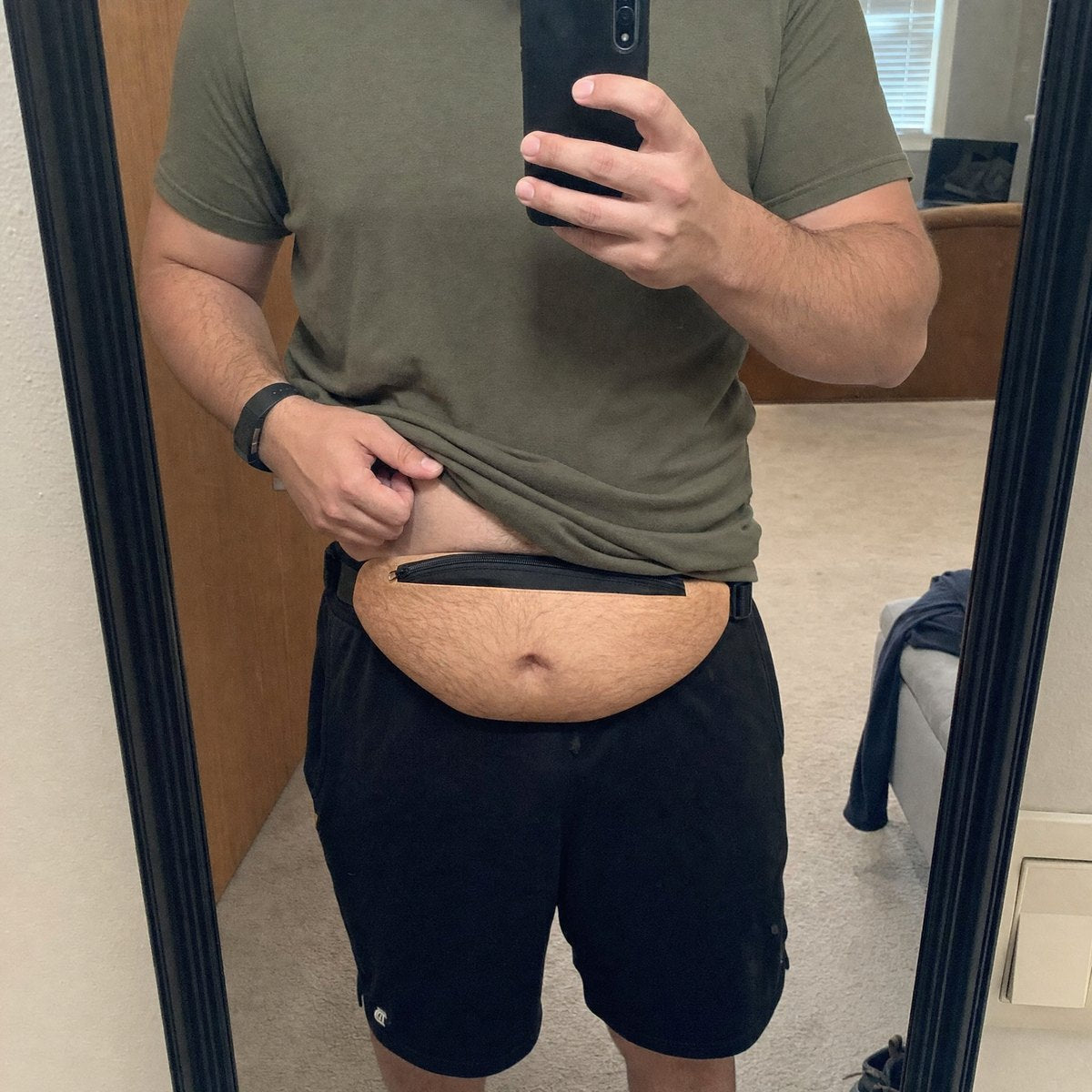 Adjusting the belly bag strap in front of a mirror